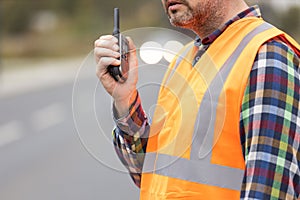 Construction workers talking to walkie-talkie