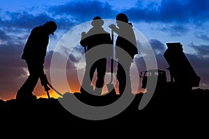 Construction Workers with Truck at Sunset Silhouette