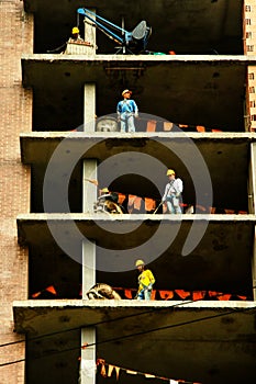 Construction workers at various heights
