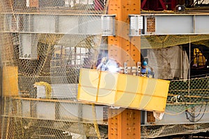 Construction workers welding on site