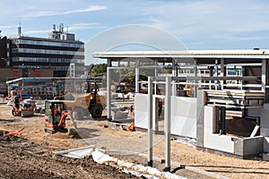 Construction workers working on building site with idustrial units