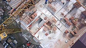 Construction workers working on a building site of new residential building.