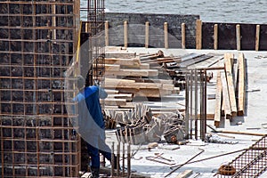 Construction workers working on cement formwork frames.