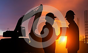 Construction workers working on a construction site at sunset for industry background