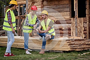 construction workers working on wooden house construct