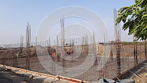 Construction works fabricating steel reinforcement bars at the construction site. Close view of the steel reinforcing bars. Column