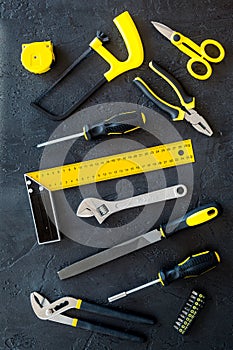 Constructor desk pattern with set of building implements dark desk background top view