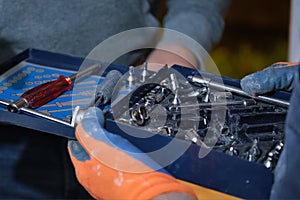 Constructor workers hands holding a torque wrench set.