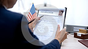 Consul worker checking visa application office, american flag, migration concept