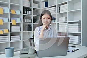 Consultant, advisor, Asian business woman working on the tablet computer work financial and marketing business plan to