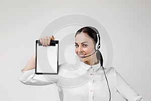 Consultant of call center in headphones holding clipboard