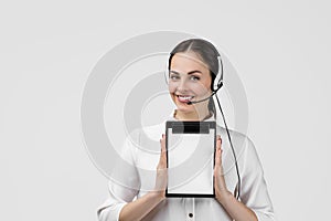 Consultant of call center in headphones holding clipboard