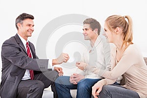 Consultant giving visiting card to couple
