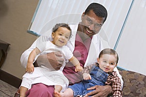 Consultant holding two IVF children photo