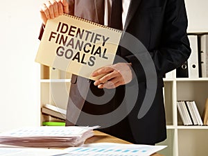 The consultant holds the inscription Identify financial goals