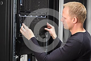 It consultant working with rack server in datacenter