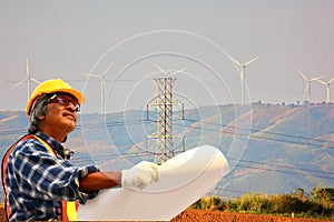 The consulting engineer in safety form is checking the construction of wind turbine electricity system  in site