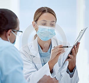 Consulting, patient and doctor with mask and documents about health, chart and results. Health, covid and physician