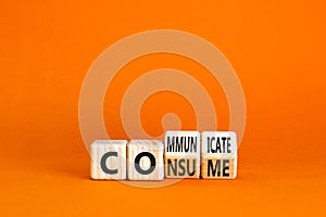 Consume or communicate symbol. Concept word Consume or Communicate on wooden cubes. Beautiful orange table orange background.