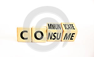 Consume or communicate symbol. Concept word Consume or Communicate on wooden cubes. Beautiful white table white background.