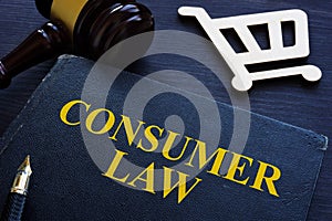 Consumer law, gavel and shopping cart on a desk