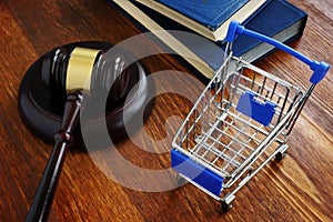 Consumer protection law concept. Shopping cart and gavel