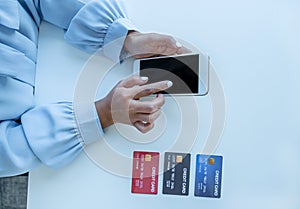 Consumer woman hand use smart phone and a mock up credit card, ready to spending pay online finance shopping according to discount