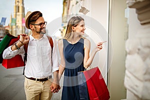 Consumerism, love, dating, travel concept. Couple enjoying shopping having fun