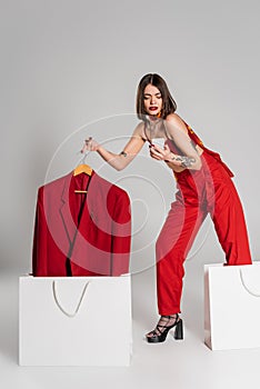 consumerism, tattooed woman with short hair