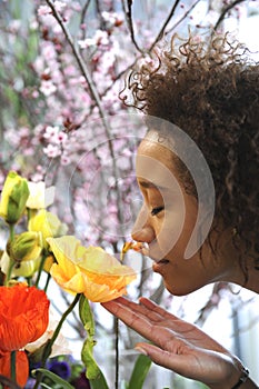 Consumerism: Woman smelling fresh flowers.