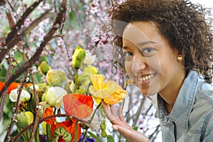 Consumerism: Woman smelling fresh flowers.