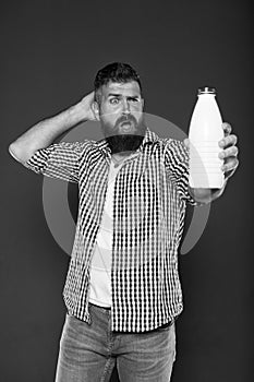 Consuming lactose. Healthy nutrition. Yogurt probiotics and prebiotics. Bearded man hold white bottle with milk. Brutal