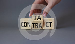 Contact and Contract symbol. Businessman hand turns wooden cubes and changes the word Contract to Contact. Beautiful grey