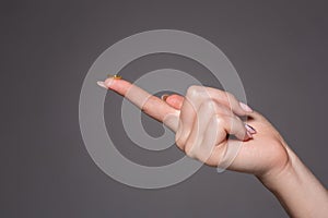 Contact eye lens. Close-up of woman holding white eye lense on finger.