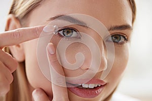 Contact Eye Lens. Smiling Woman Applying Eye Contacts on her Eyes