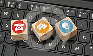 Contact Icons on black keyboard wood dices