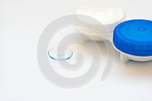 Contact lens and contact lens case on white background. Soft focus. Macro. Opthalmology and health concept