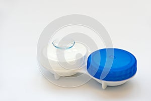 Contact lens on contact lens case on white background. Soft focus. Macro. Opthalmology and health concept
