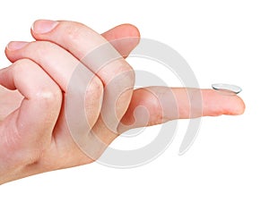 Contact lens on the index finger of female hand