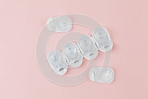 Contact lens packages a pink background. Stack of healthcare disposable contact lens.