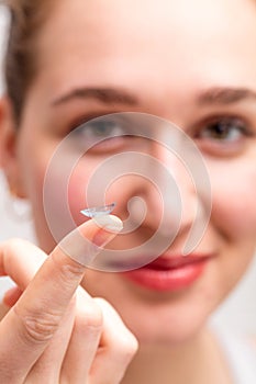 Contact lens shown of blurred happy young woman for wellbeing