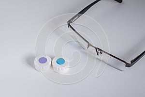 Contact lenses in a case and glasses
