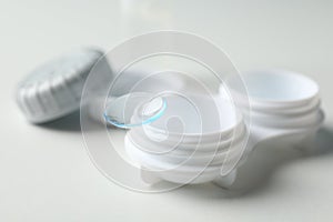 Contact lenses and case on white background