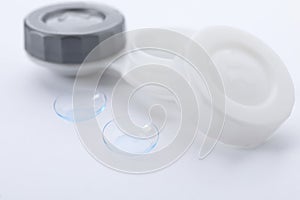 Contact lenses and case on white background, closeup