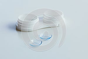 Contact lenses and case on white background. Eye health and care, eyesight and vision, ophthalmology and optometry