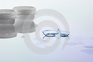 Contact lenses and case on white background. Eye health and care, eyesight and vision, ophthalmology and optometry photo