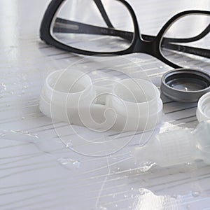 Contact lenses in container, bottle with solution, glasses