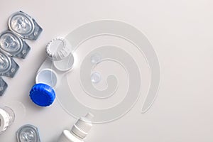 Contact lenses containers and solutions on white table top