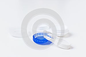 Contact lenses in containers with tweezers.