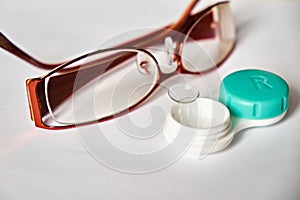 Contact lenses and glasses on a white background. The topic of medicine and health care. Up close